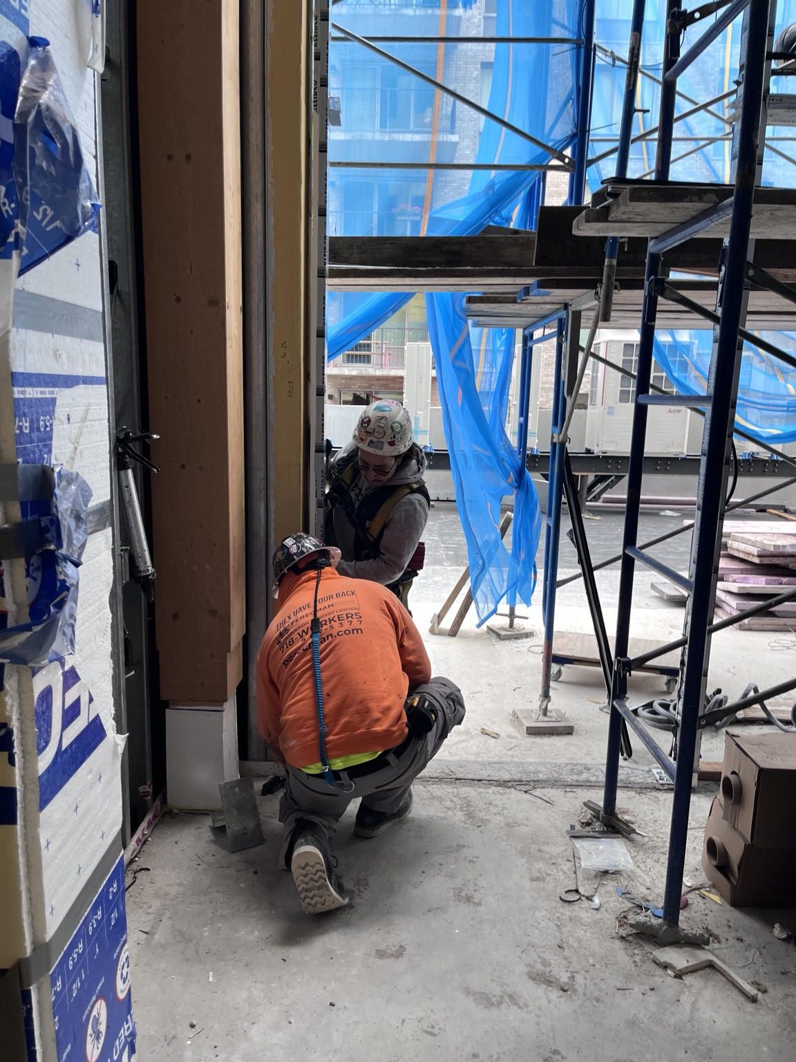 GDM installers working at a window opening at 179 N 10