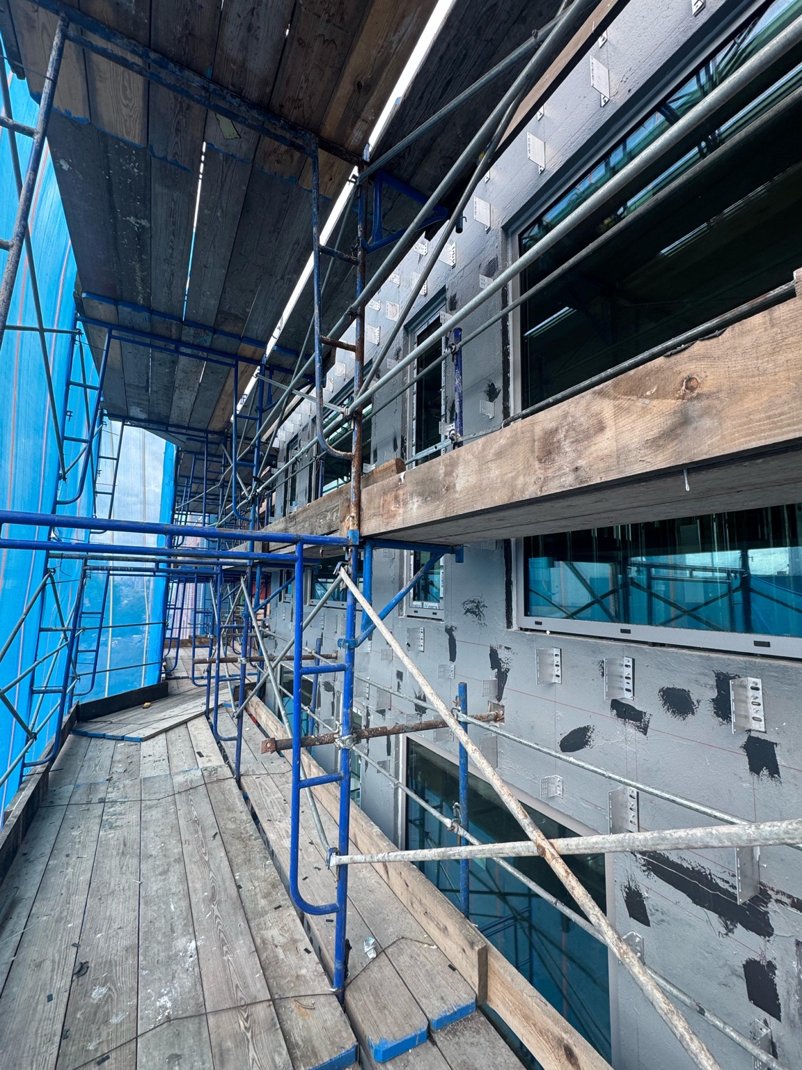 Multi-story window installation progress at 179 N 10