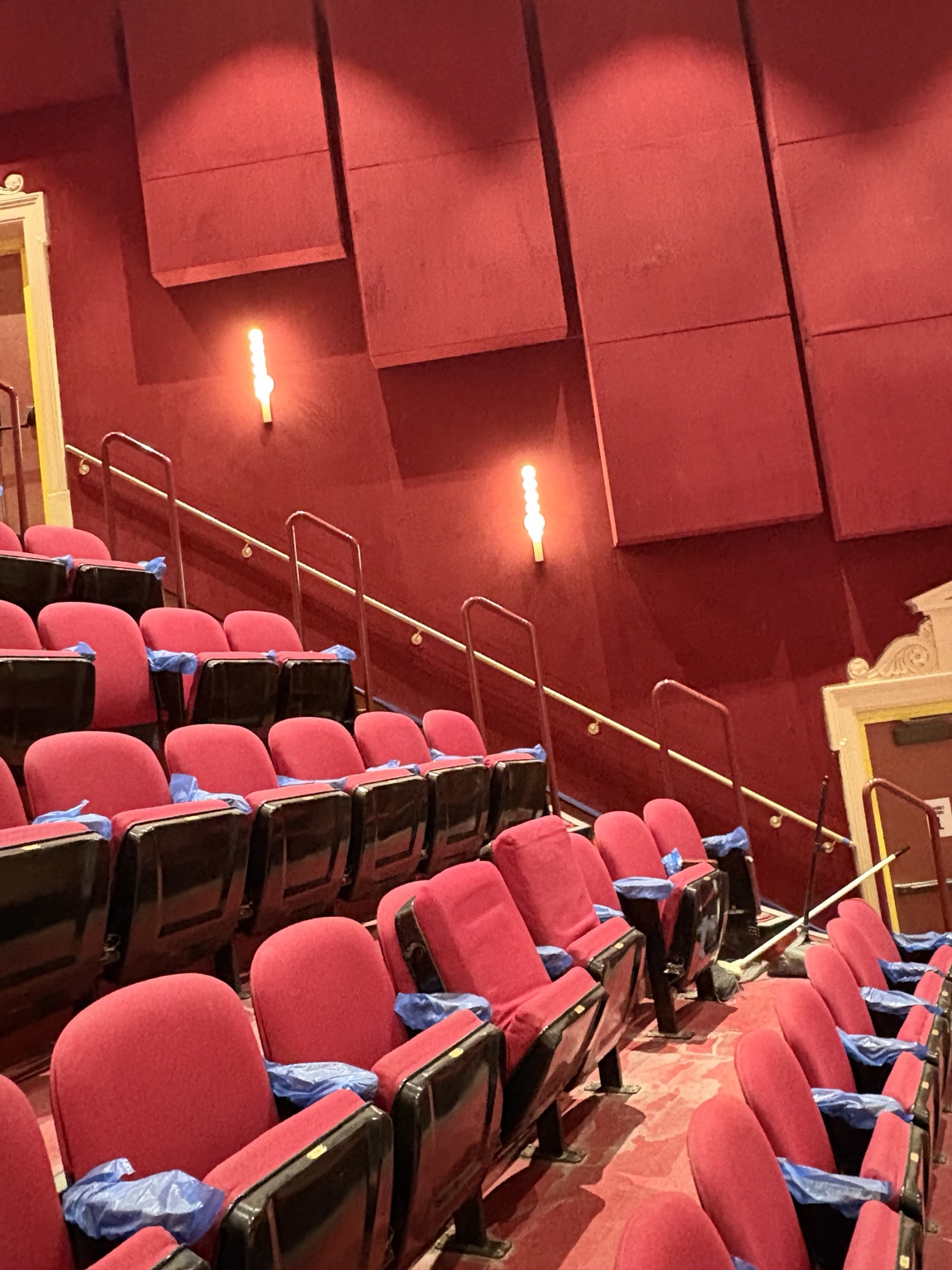 Antique brass handrails installed along the seating aisles inside the Apollo Theater