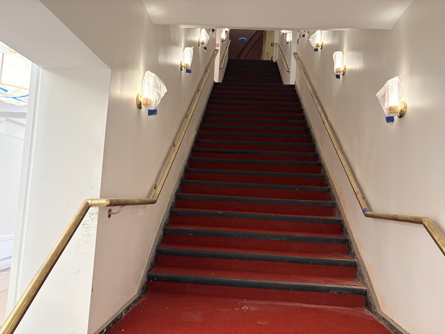 Decorative metal handrails following both sides of the Apollo Theater stairs