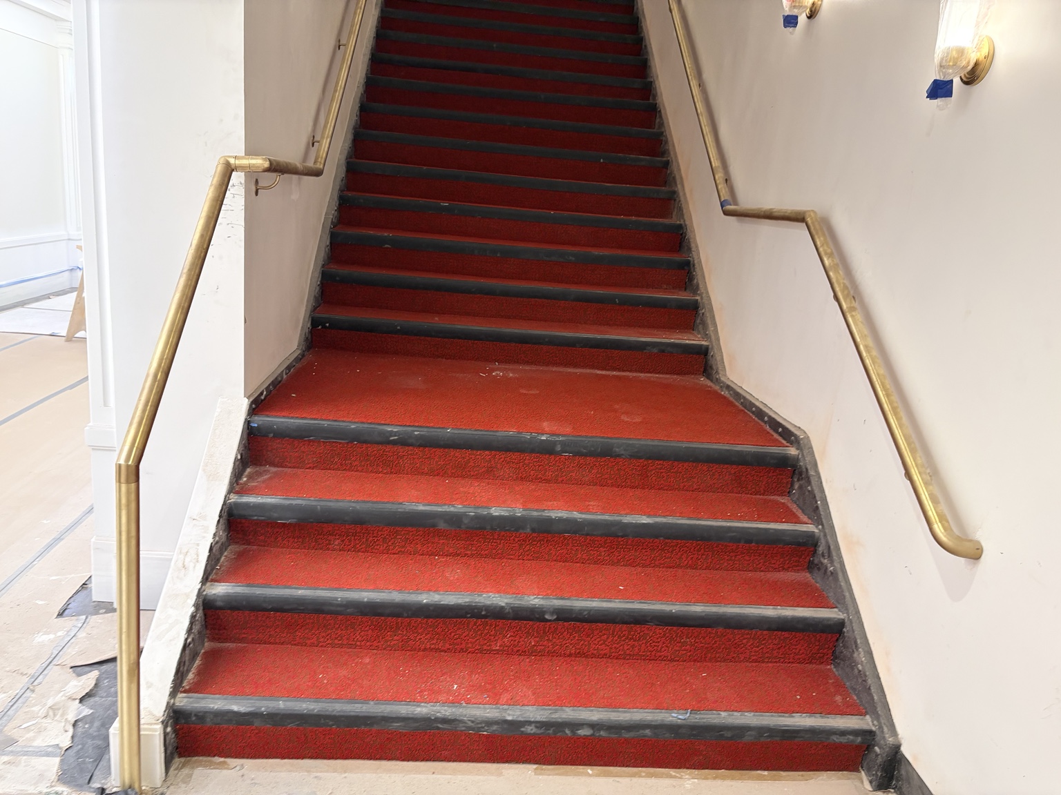 Decorative metal handrail transitions at an Apollo Theater stair landing